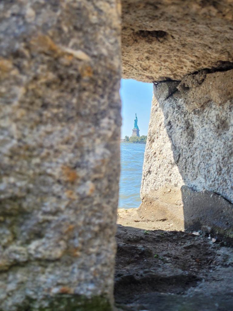 View of statue of liberty from wall at Ellis Island