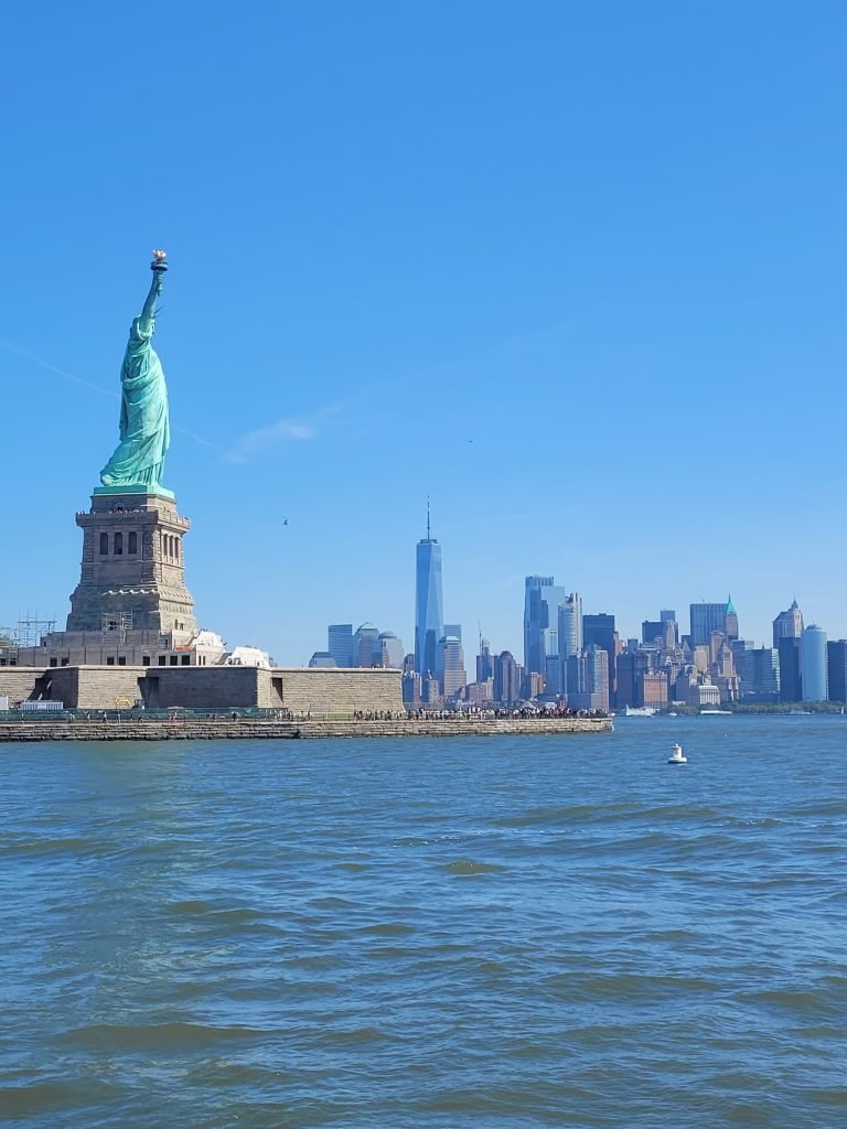 Photo of Statue of Liberty Manhattan in background.  