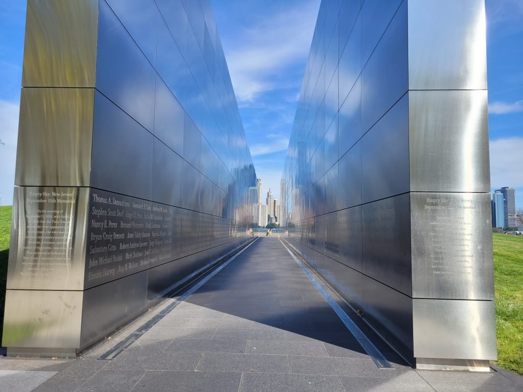 Photo between stainless steel walls of Manhatten of empty sky memorial at Liberty Park.